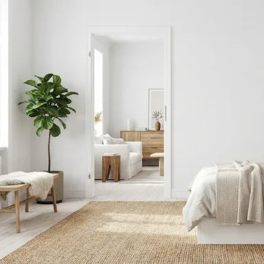 Hier ist eine eingebaute weiße Zarge in einem warmen, hellen und gemütlichen Schlafzimmer zu sehen.